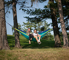 Students sitting in a hammock. Link to Life Stage Gift Planner Under Age 60 Situations.